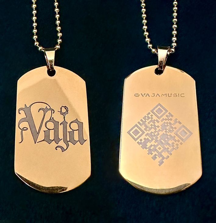 Gold glossy Vaja dog tags with a gold chain.