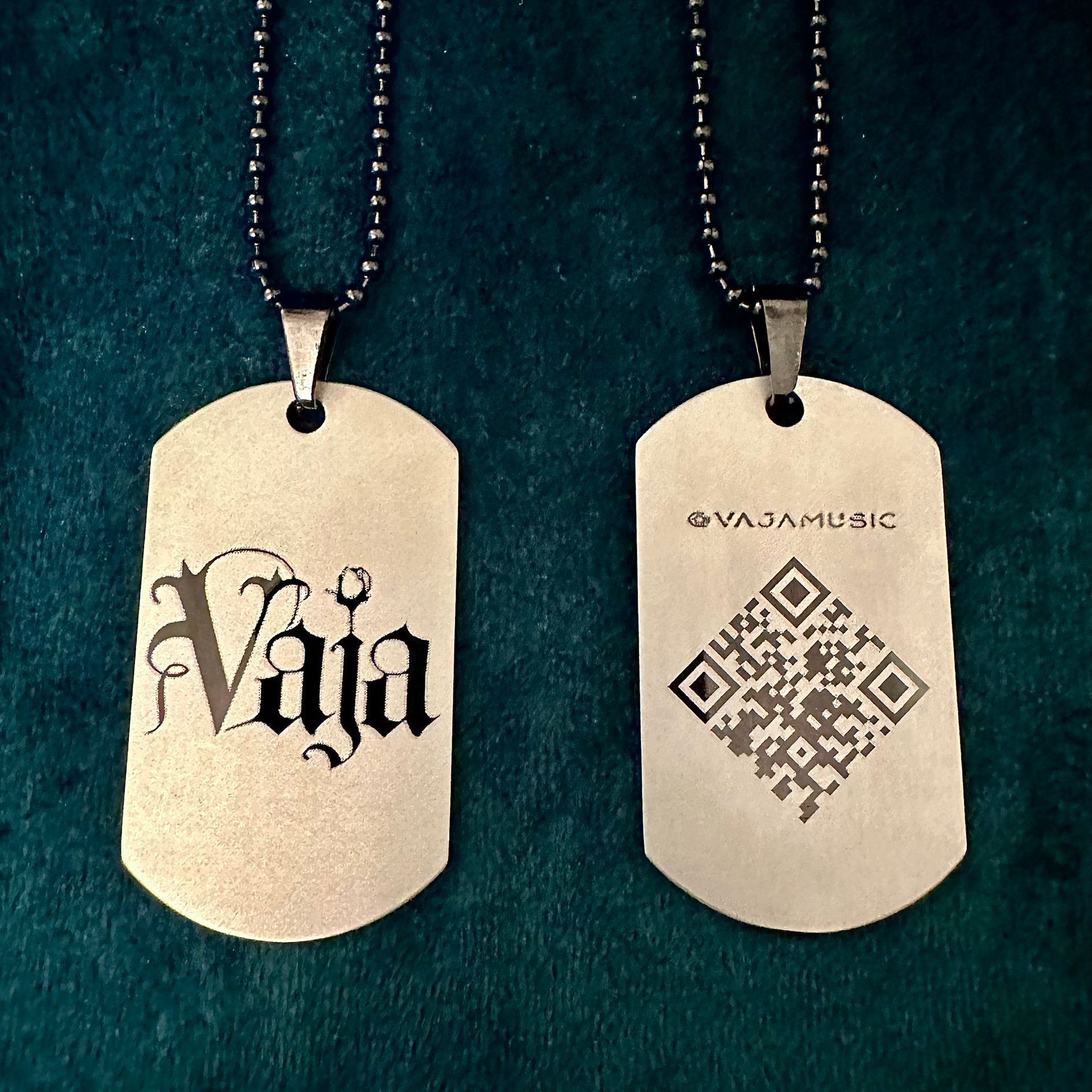 Silver matte Vaja dog tags with a black Vaja logo and black chain.