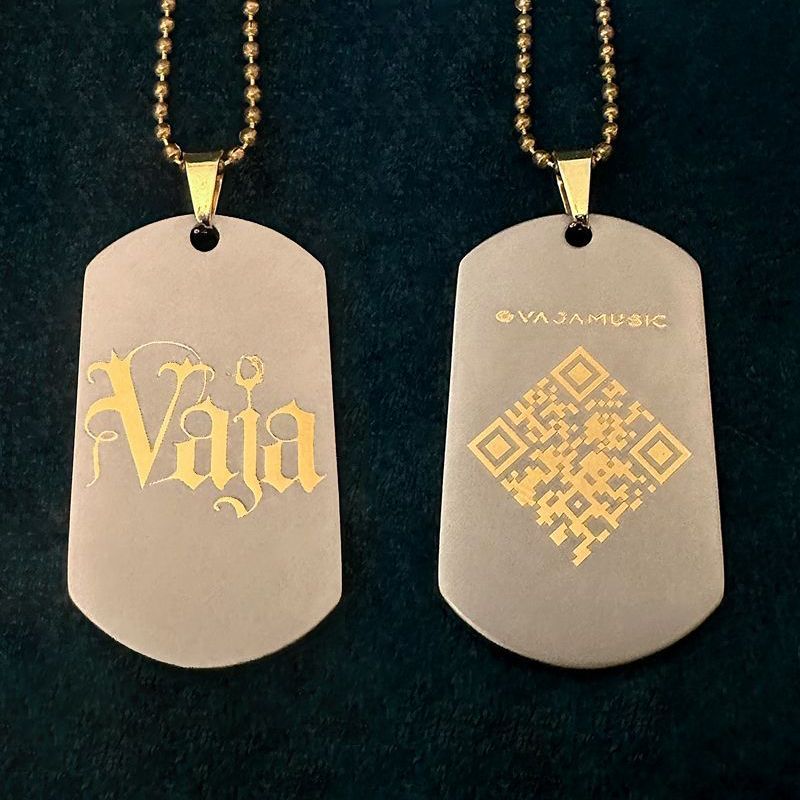 Gold matte Vaja dog tags with a gold chain.
